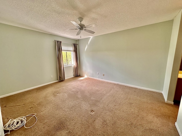 spare room with carpet, a textured ceiling, and ceiling fan