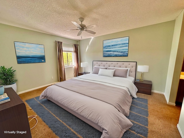 carpeted bedroom featuring ceiling fan and a textured ceiling