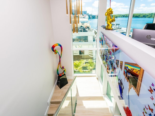 interior space with light hardwood / wood-style floors and a water view