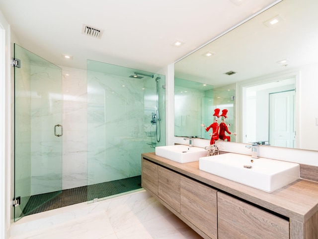 bathroom featuring an enclosed shower and vanity