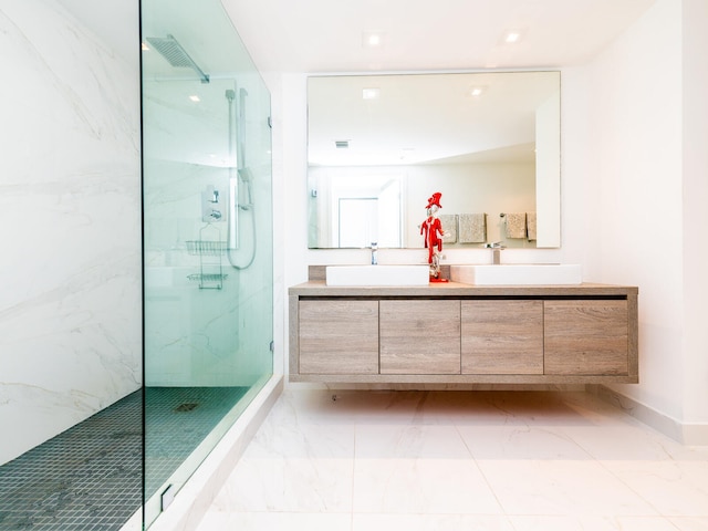 bathroom with vanity and a tile shower