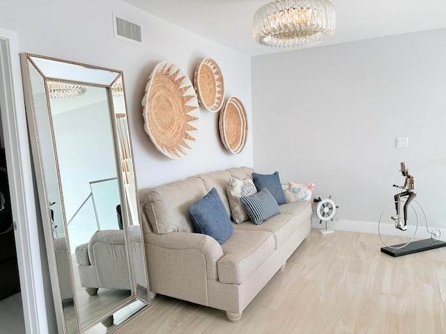 living room with a chandelier and wood-type flooring