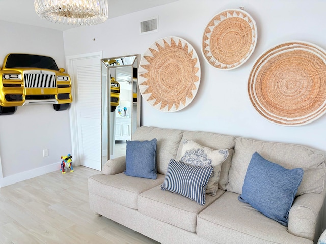 living room with hardwood / wood-style flooring and an inviting chandelier