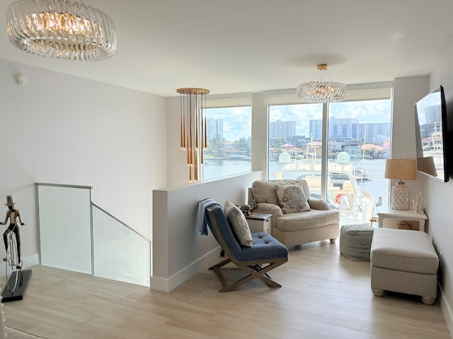 living area featuring a notable chandelier and light hardwood / wood-style floors