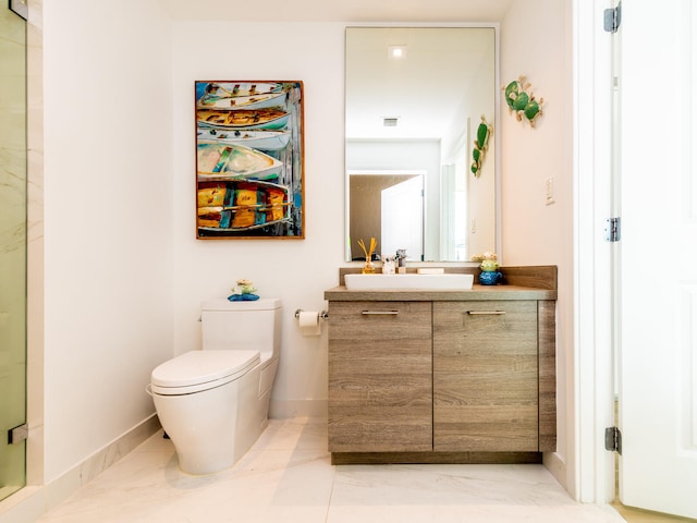 bathroom featuring a shower with door, vanity, and toilet