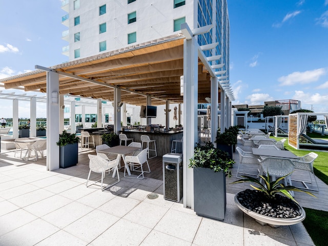 view of patio / terrace featuring an outdoor bar and a pergola