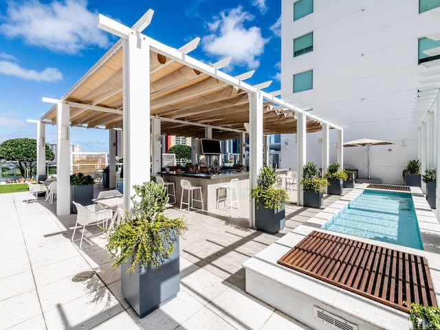 view of patio with an outdoor bar and a pergola