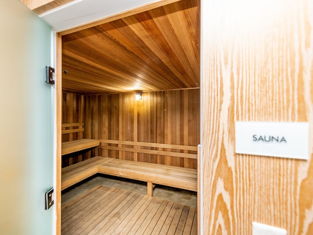 view of sauna featuring wooden walls and wooden ceiling