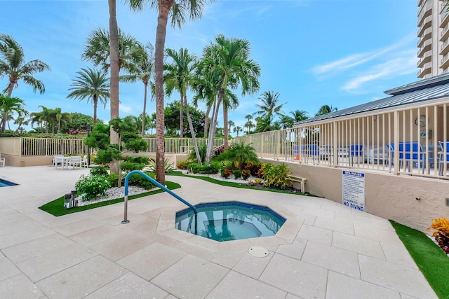 view of pool with a patio and a community hot tub