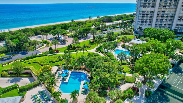 birds eye view of property with a water view and a beach view