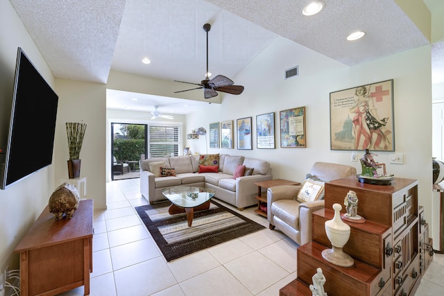 living room featuring a textured ceiling, high vaulted ceiling, light tile patterned flooring, and ceiling fan