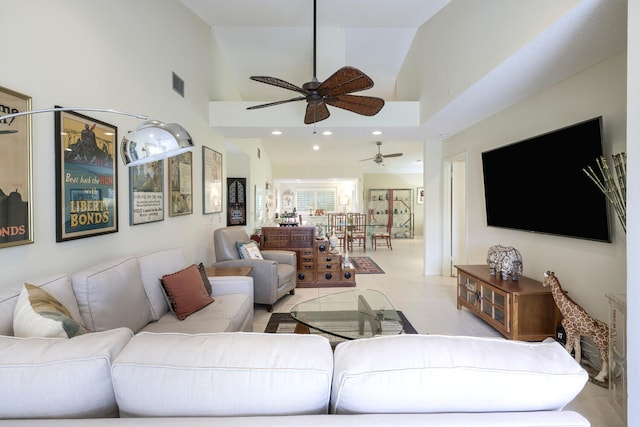 living room featuring high vaulted ceiling, ceiling fan, and light tile patterned floors