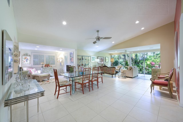 dining space featuring lofted ceiling, light tile patterned flooring, and ceiling fan