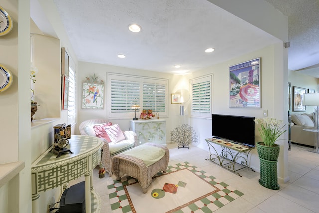 tiled living room with a textured ceiling