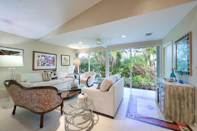 tiled living room with a textured ceiling, a wealth of natural light, and lofted ceiling