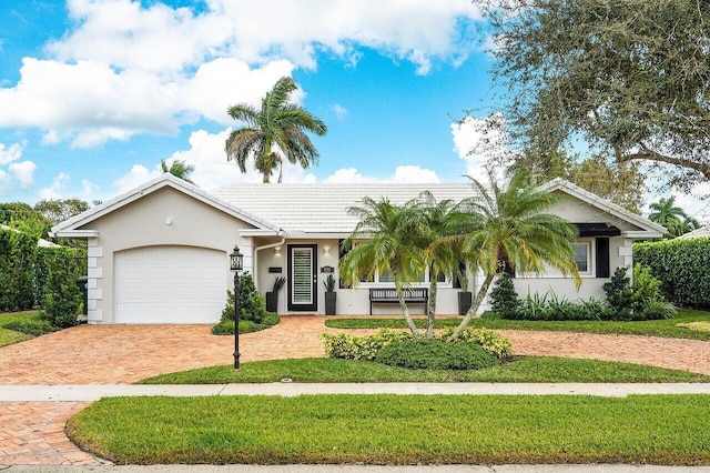 view of front facade featuring covered porch, a garage, and a front lawn