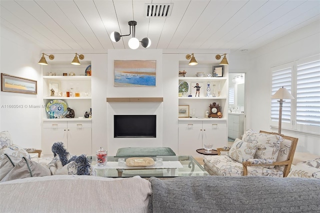 living room featuring wood ceiling and built in features