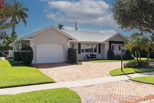 ranch-style home with a front yard and a garage