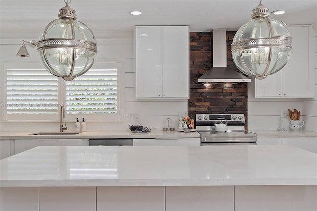 kitchen featuring decorative backsplash, exhaust hood, stainless steel appliances, sink, and white cabinets