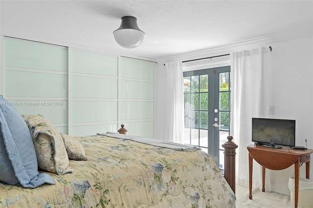 carpeted bedroom featuring french doors and access to outside