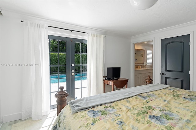 bedroom with connected bathroom, french doors, access to outside, crown molding, and sink