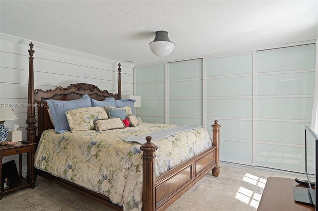 carpeted bedroom featuring a textured ceiling