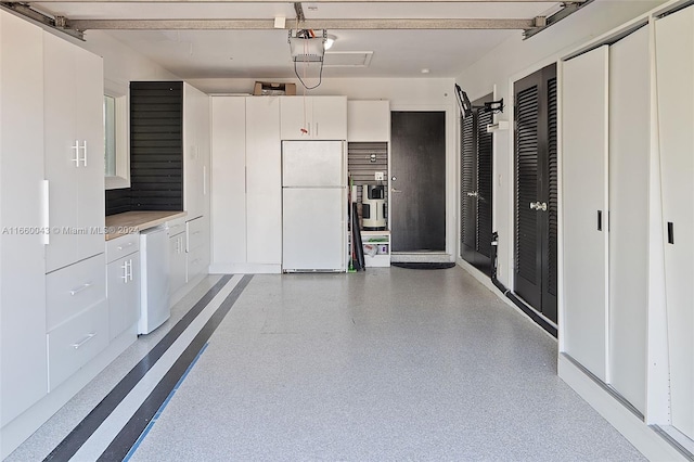 garage featuring white fridge