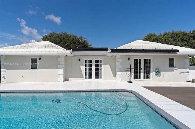 view of pool featuring french doors and a patio area