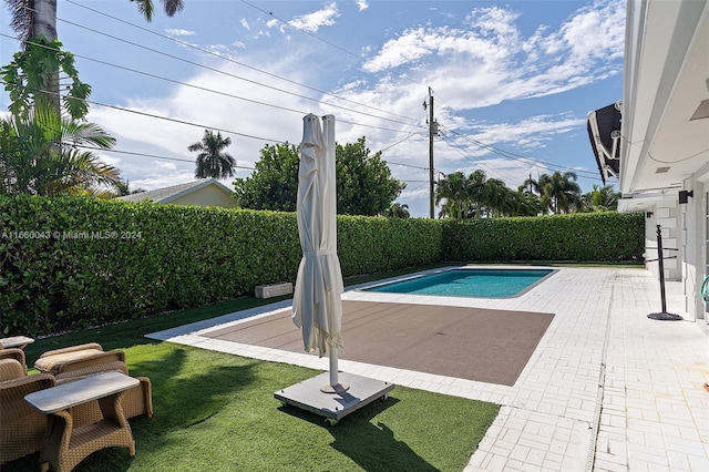 view of swimming pool with a yard and a patio area