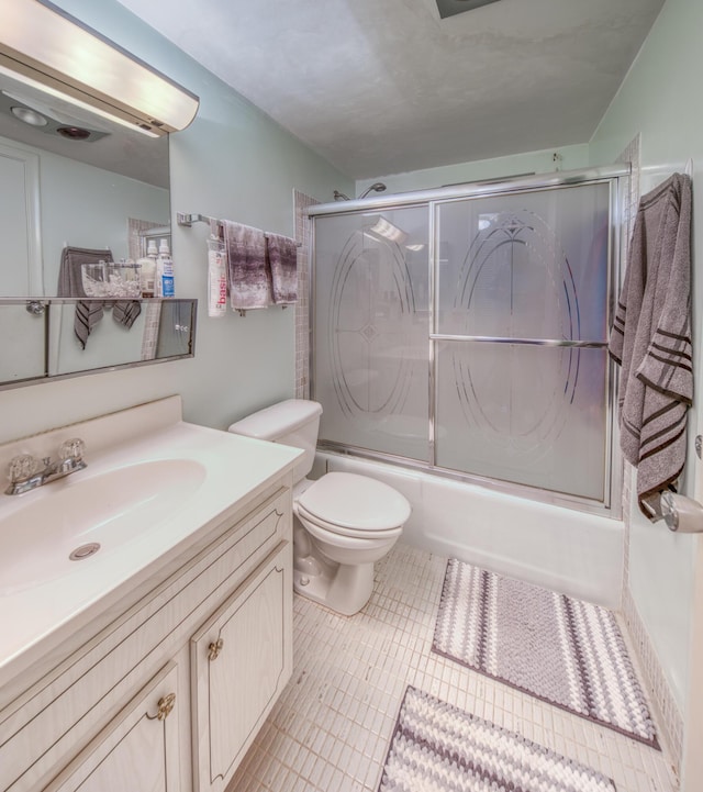 3040 Lake Osborne Dr Unit 106, Lake Worth Beach, FL 33461 - bathroom featuring bath / shower combo with glass door, vanity, and toilet