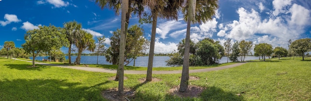 surrounding community featuring a yard and a water view