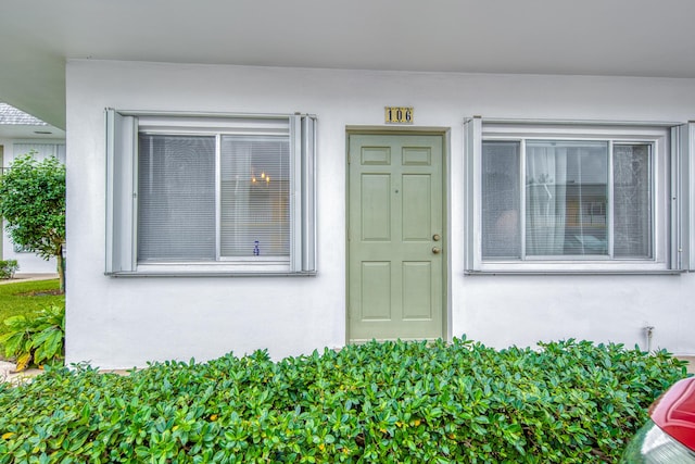 3040 Lake Osborne Dr Unit 106, Lake Worth Beach, FL 33461 - property entrance with stucco siding