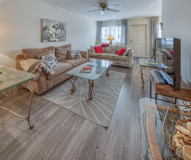 living room featuring wood-type flooring and ceiling fan