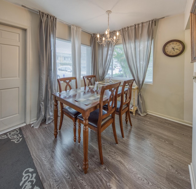3040 Lake Osborne Dr Unit 106, Lake Worth Beach, FL 33461 - dining space featuring a chandelier, wood finished floors, plenty of natural light, and baseboards