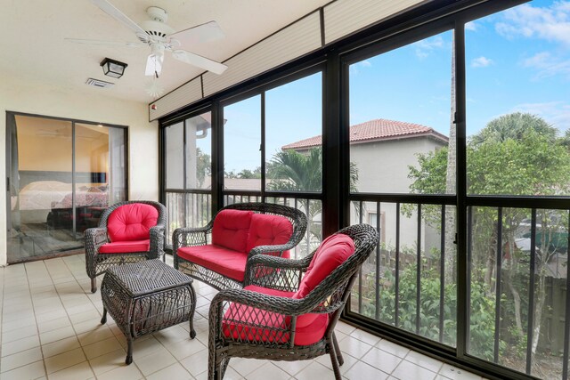 sunroom featuring ceiling fan