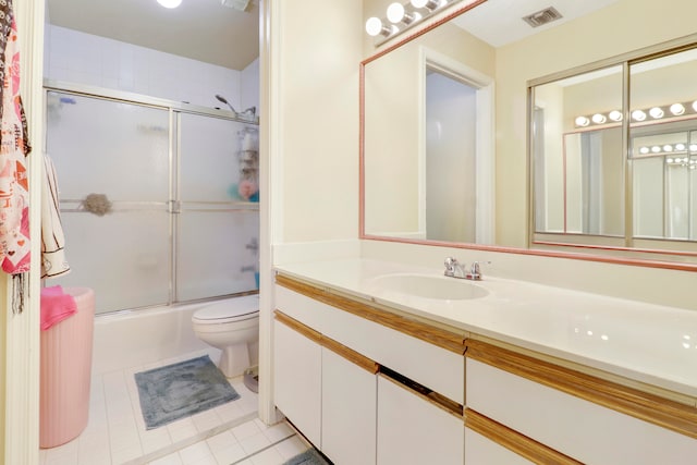 full bathroom featuring toilet, vanity, shower / bath combination with glass door, and tile patterned flooring