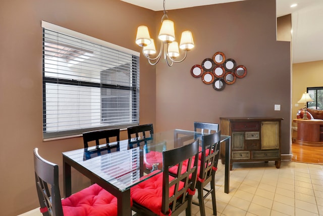 tiled dining area with a chandelier