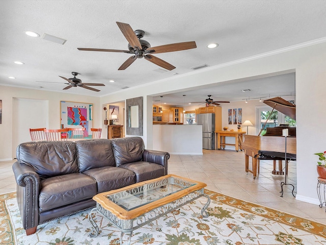 tiled living room featuring ornamental molding, a textured ceiling, and ceiling fan