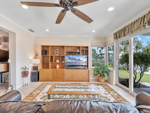 living room featuring crown molding, ceiling fan, a textured ceiling, and light tile patterned floors