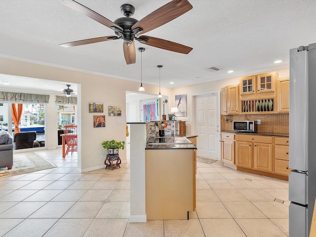 kitchen with light tile patterned flooring, decorative light fixtures, stainless steel appliances, and backsplash