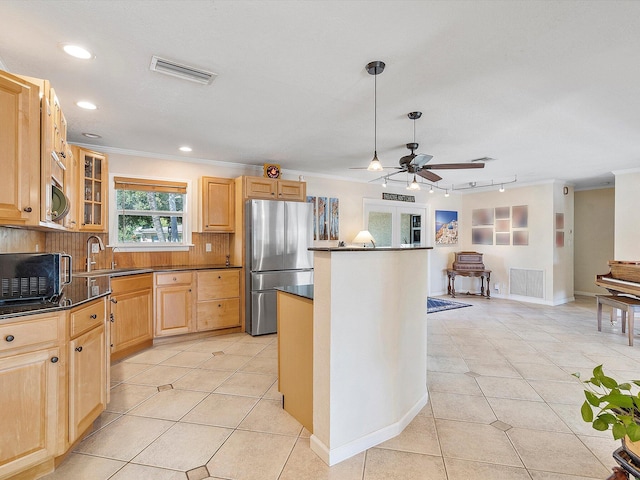 kitchen featuring ceiling fan, appliances with stainless steel finishes, light tile patterned floors, and light brown cabinets