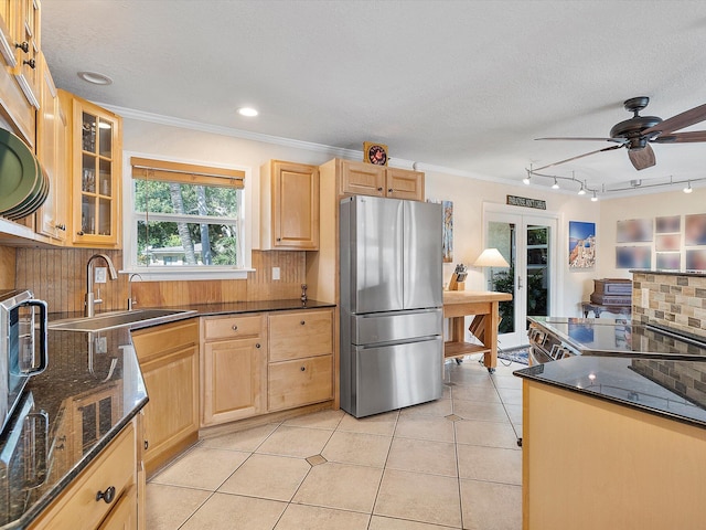 kitchen with backsplash, light brown cabinetry, stainless steel refrigerator, ornamental molding, and sink