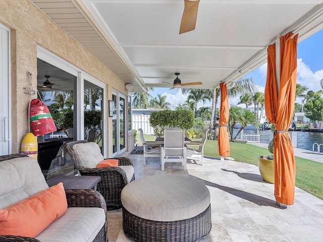 view of patio / terrace featuring french doors, an outdoor hangout area, a water view, and ceiling fan