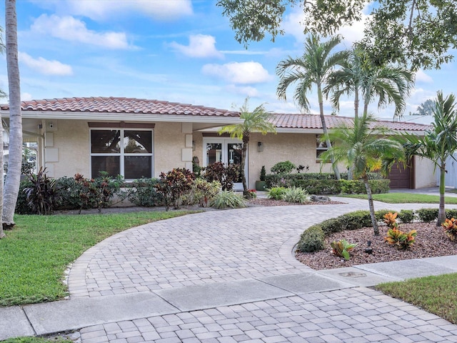 view of front of house with a front yard and a garage