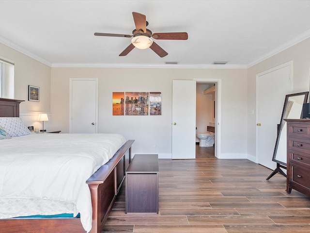 bedroom with crown molding, ensuite bathroom, dark wood-type flooring, and ceiling fan