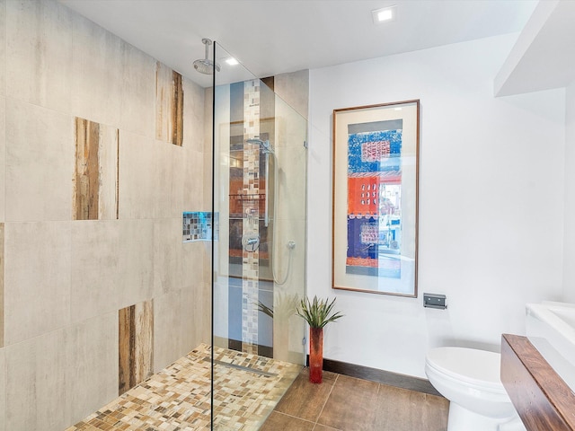 bathroom with toilet, tile patterned floors, and tiled shower