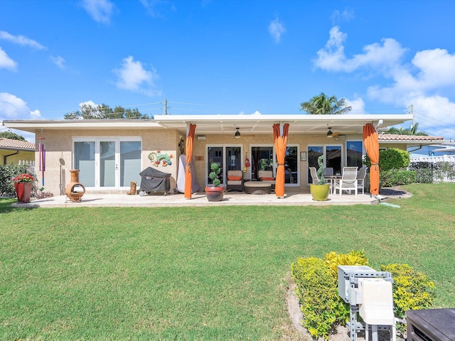 back of house featuring french doors, a yard, an outdoor hangout area, a patio, and ceiling fan