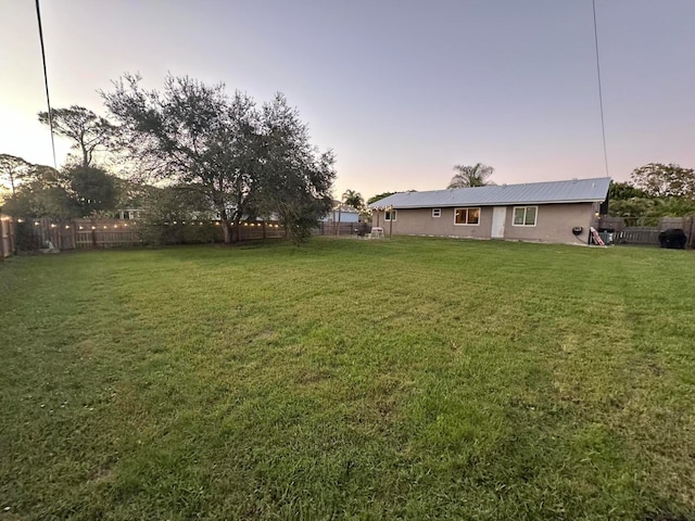 view of yard at dusk