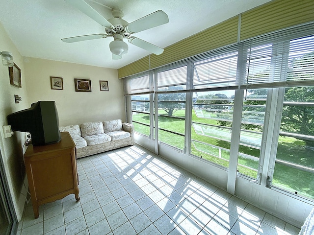 sunroom / solarium featuring ceiling fan