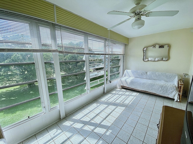 unfurnished sunroom with plenty of natural light and ceiling fan